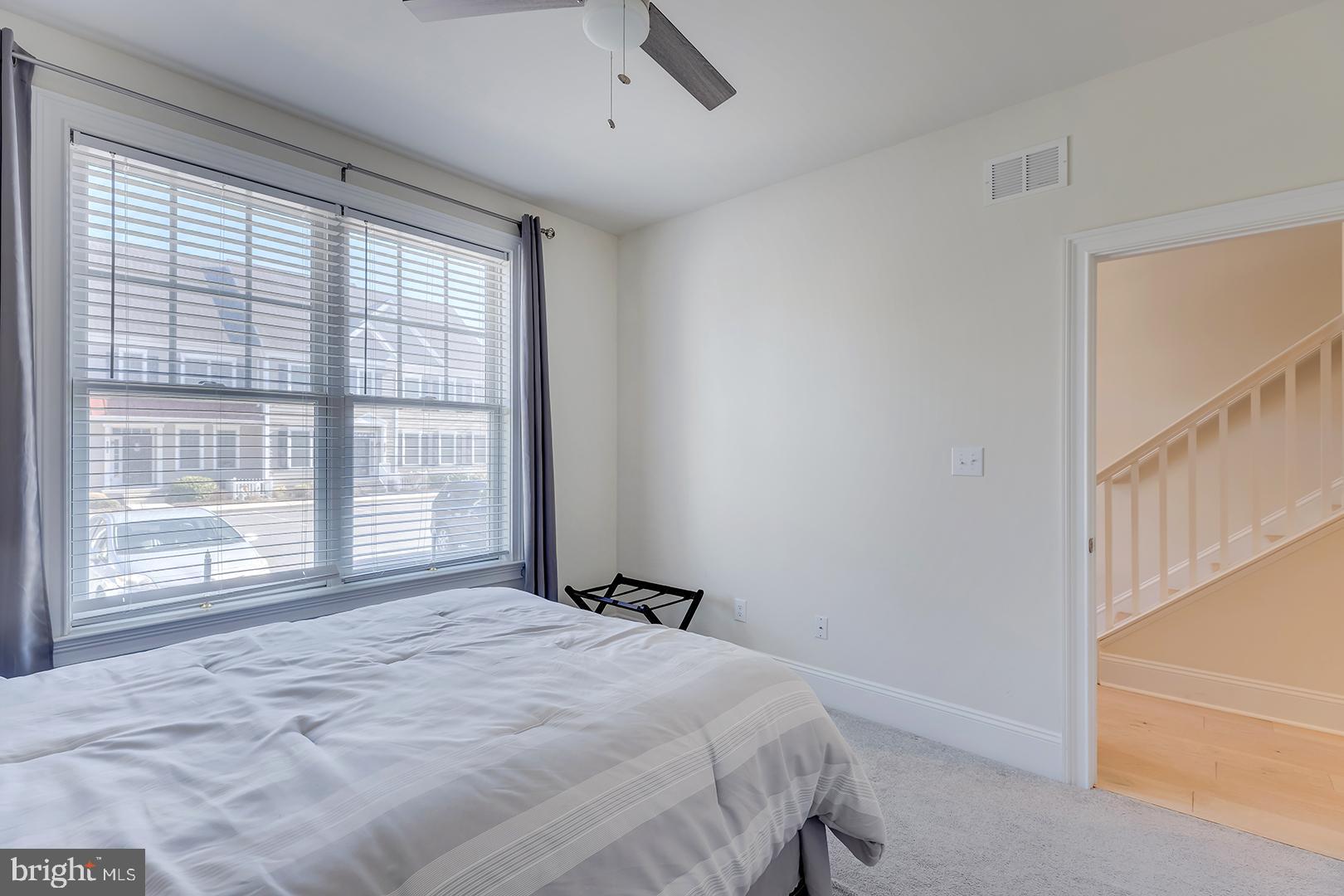 18799 Bethpage Drive, Unit 16E Lewes, DE 19958 - Photo 37 of 68 a bedroom with a bed and a window