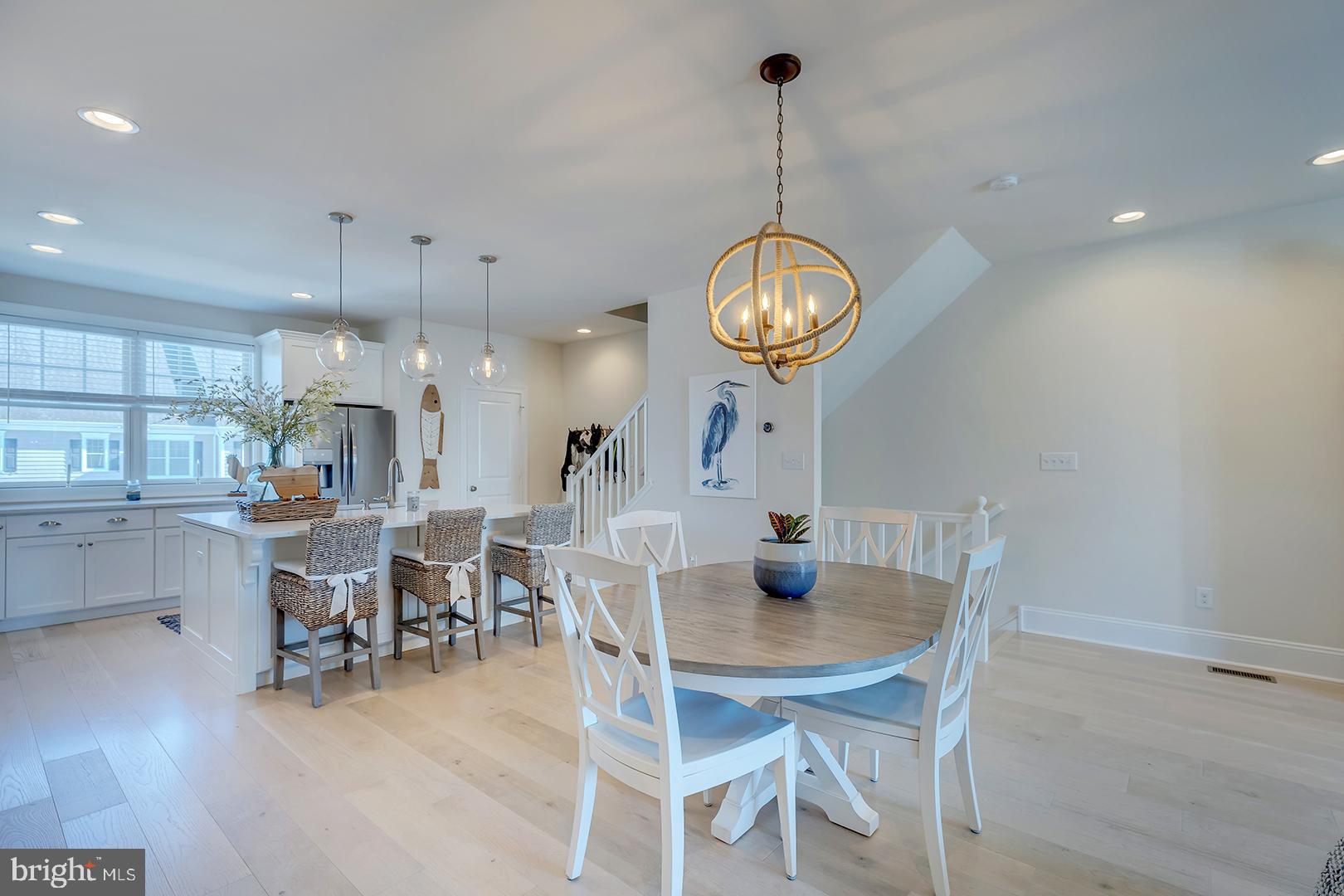 18799 Bethpage Drive, Unit 16E Lewes, DE 19958 - Photo 4 of 68 a view of a dining room and livingroom view with furniture wooden floor a rug a painting and a chandelier