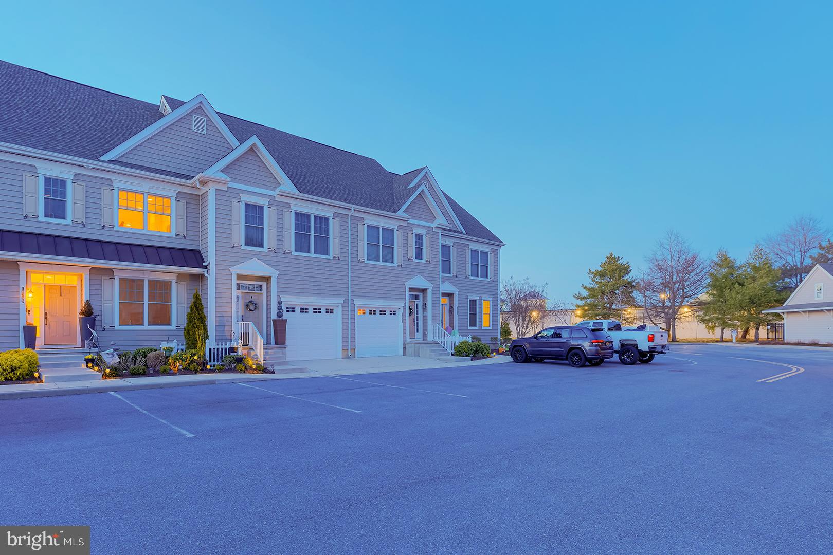 18799 Bethpage Drive, Unit 16E Lewes, DE 19958 - Photo 53 of 68 a cars parked in front of a brick building