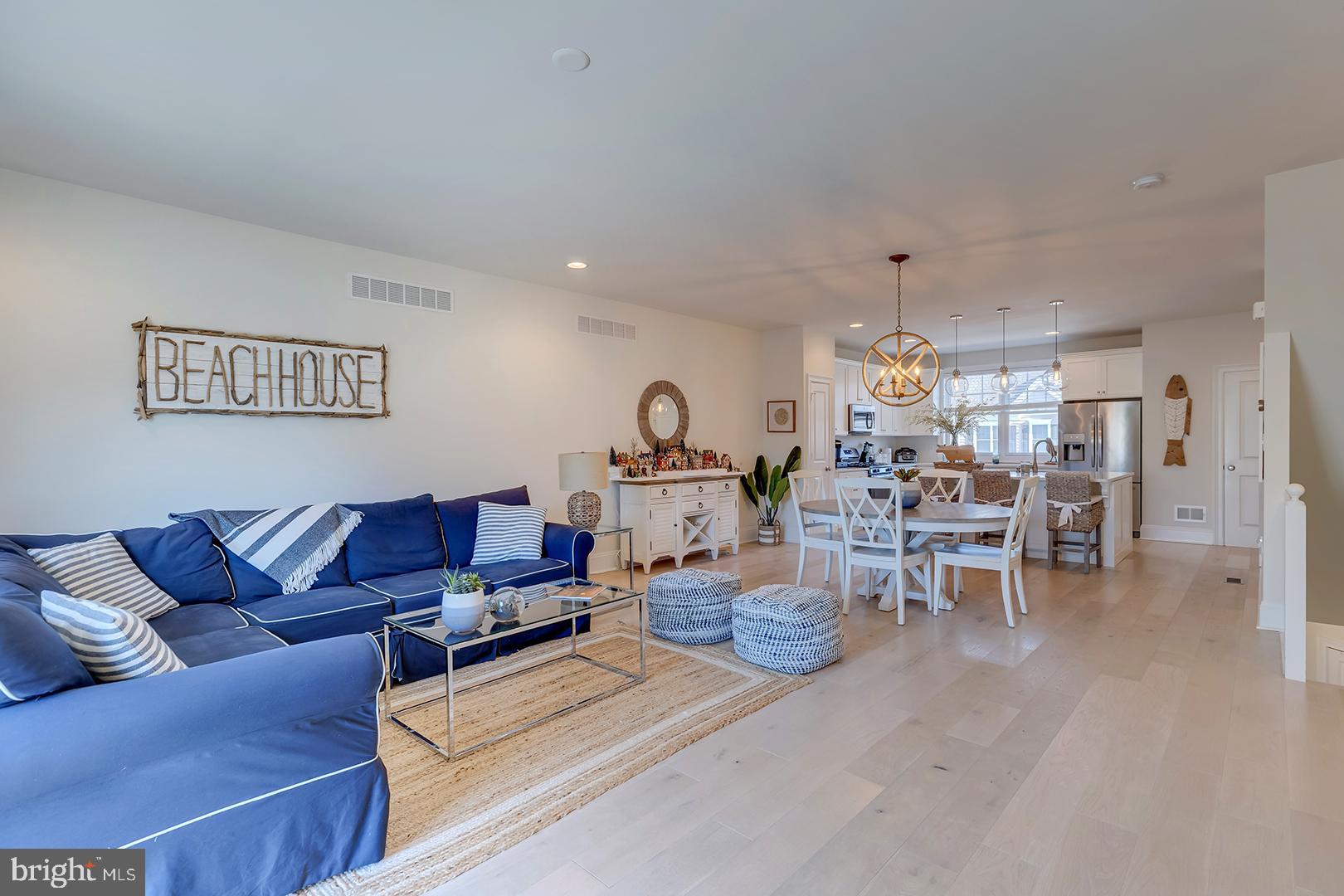 18799 Bethpage Drive, Unit 16E Lewes, DE 19958 - Photo 6 of 68 a living room with furniture and a chandelier