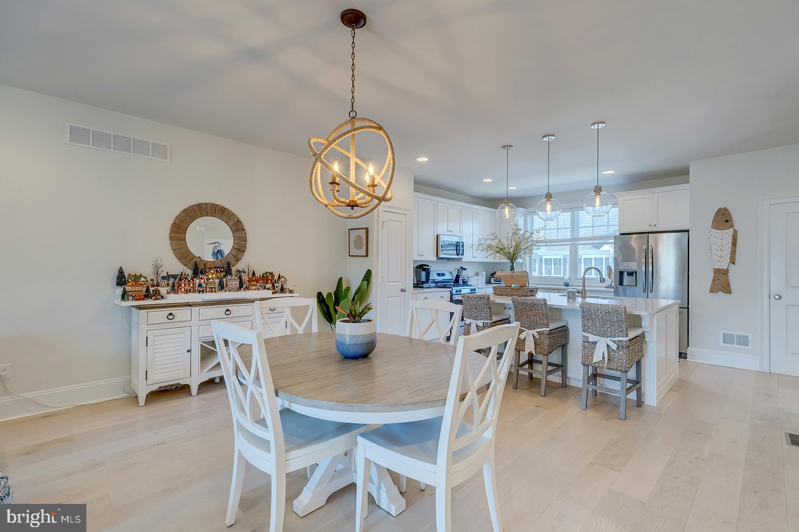 18799 Bethpage Drive, Unit 16E Lewes, DE 19958 - Photo 9 of 68 a view of a dining room and livingroom with furniture wooden floor a chandelier