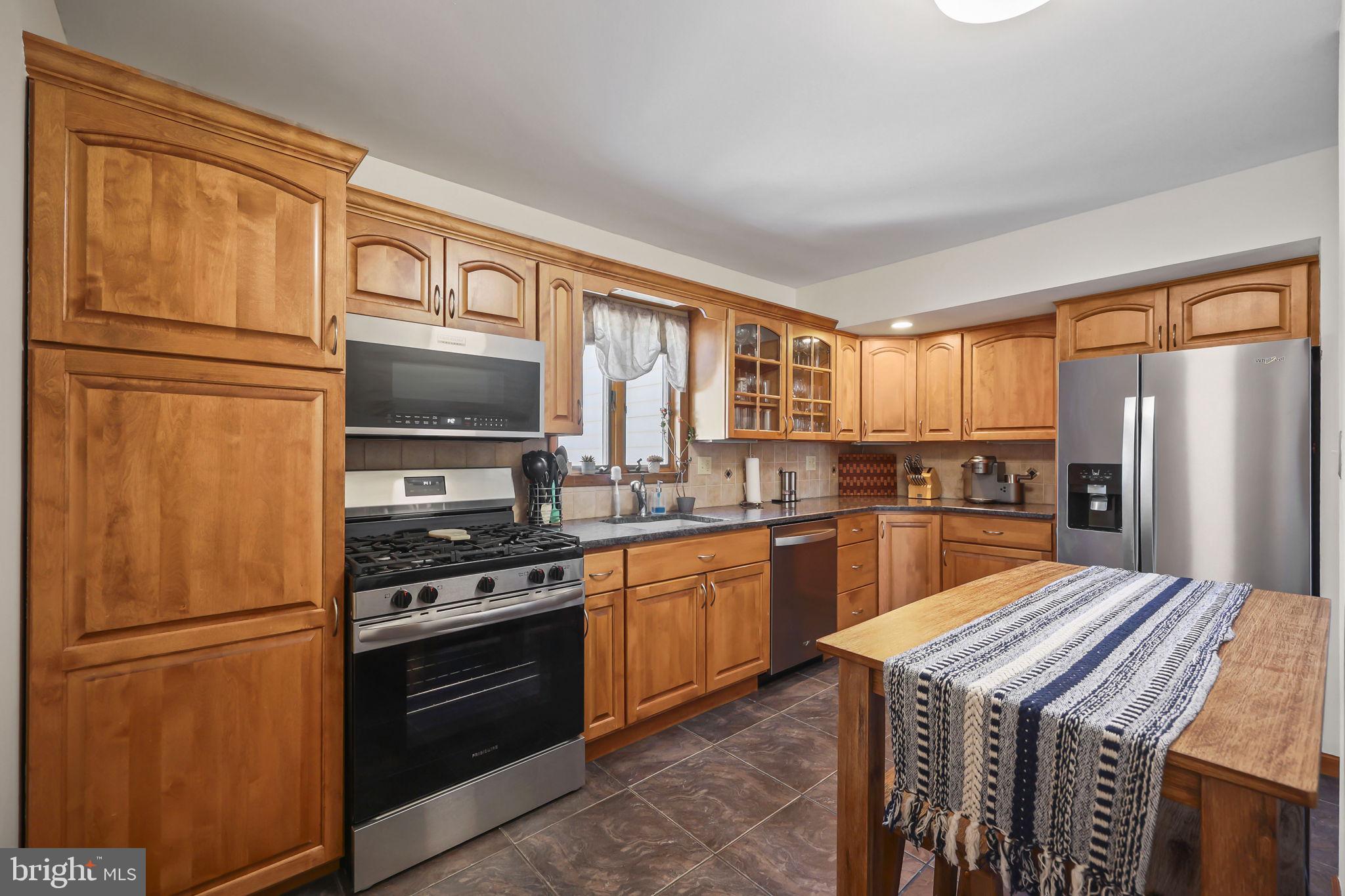 17 Maguire Road Hamilton, NJ 08690 - Photo 17 of 37 a kitchen with stainless steel appliances granite countertop a refrigerator a stove top oven a sink and dishwasher