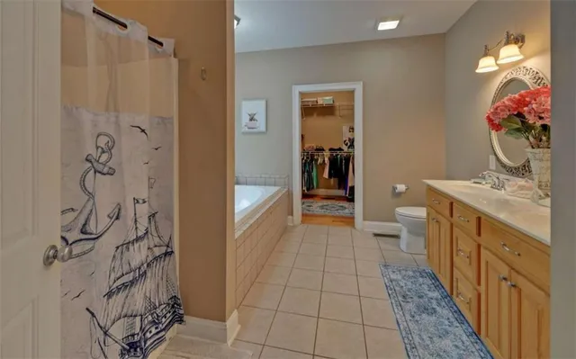a bathroom with a tub a sink and a window