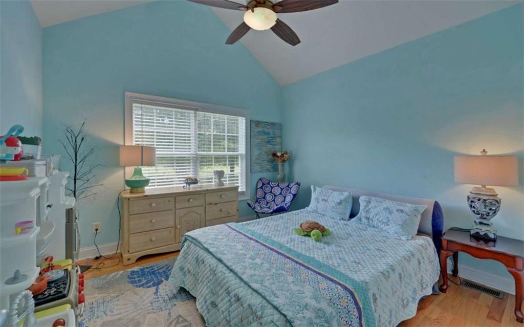 234 Dh Green Road Demorest, GA 30535 - Photo 22 of 57 a bedroom with a bed and a chandelier