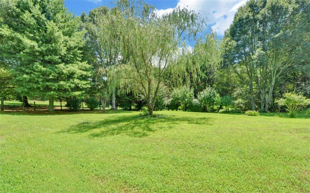 234 Dh Green Road Demorest, GA 30535 - Photo 33 of 57 a view of a field with trees in the background