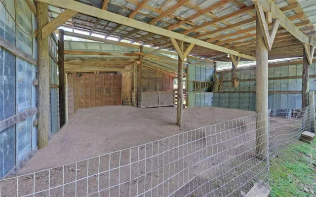 a view of a yard with wooden fence