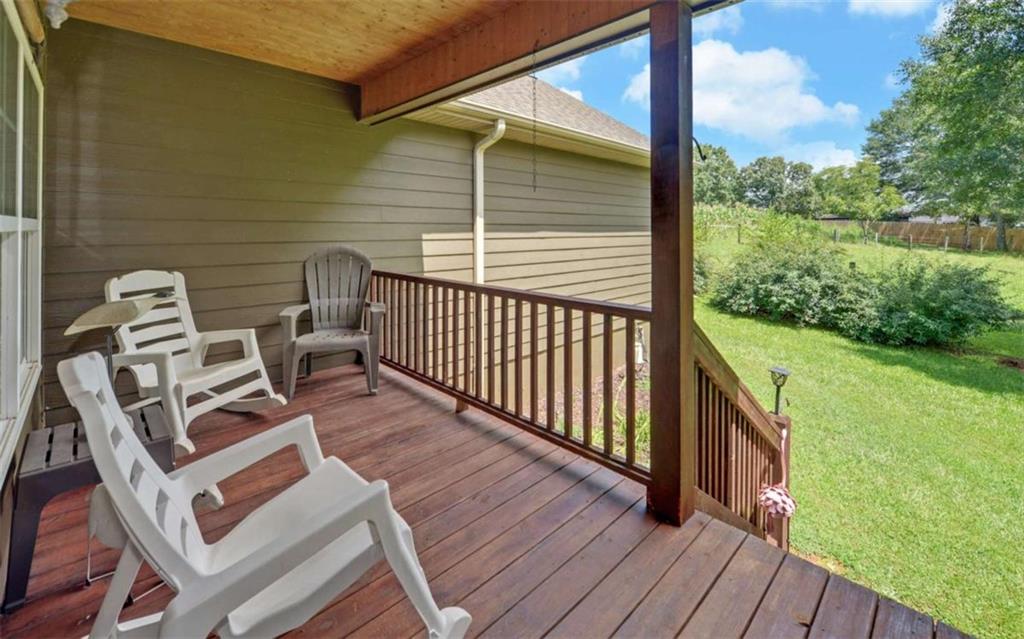 234 Dh Green Road Demorest, GA 30535 - Photo 4 of 57 a view of a balcony with wooden floor and iron fence