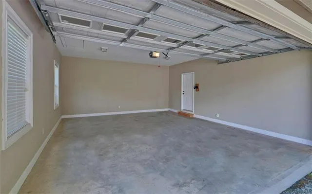 an aerial view of a house with a garden and lake view
