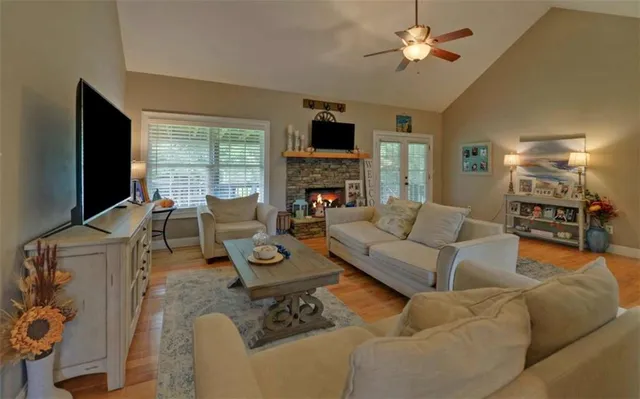 a living room with furniture a fireplace and a flat screen tv
