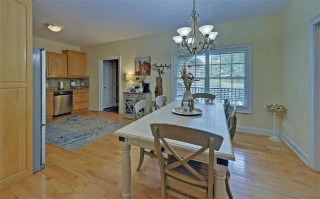 a kitchen with stainless steel appliances granite countertop a refrigerator a stove top oven a sink and dishwasher