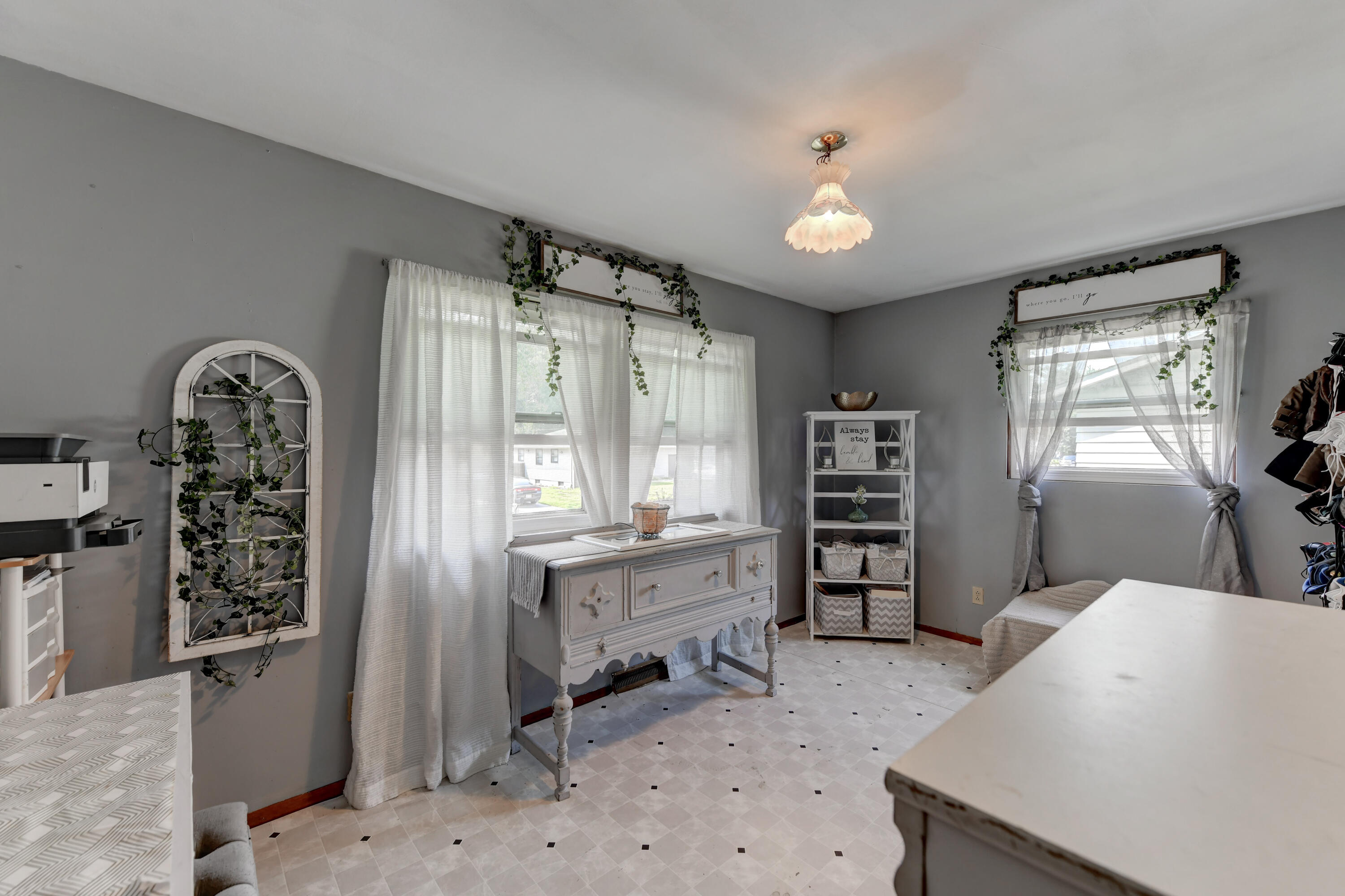 3706 Lexington Road Michigan City, IN 46360 - Photo 9 of 22 a large kitchen with stainless steel appliances a stove a refrigerator a oven a dining table and chairs with wooden floor