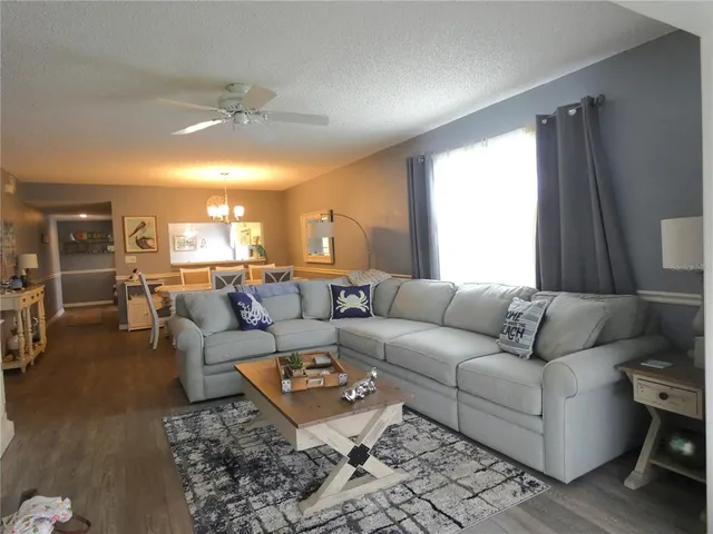 a living room with furniture and a chandelier