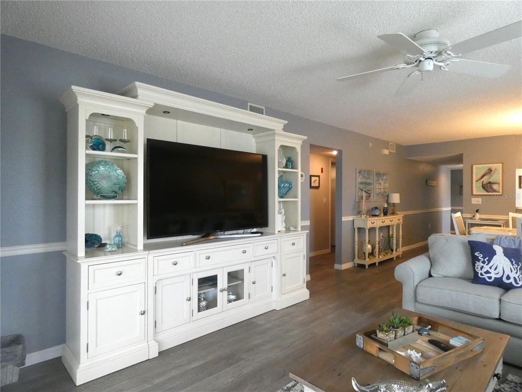 9320 Clubside Circle, Unit 2208 Sarasota, FL 34238 - Photo 14 of 41 a living room with furniture and a flat screen tv