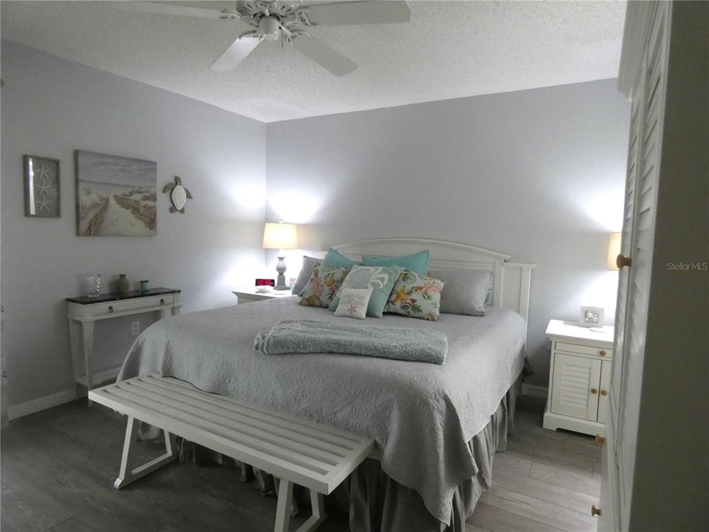 9320 Clubside Circle, Unit 2208 Sarasota, FL 34238 - Photo 15 of 41 a bedroom with a bed and a table in it