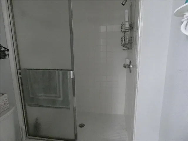 a bathroom with a glass shower door