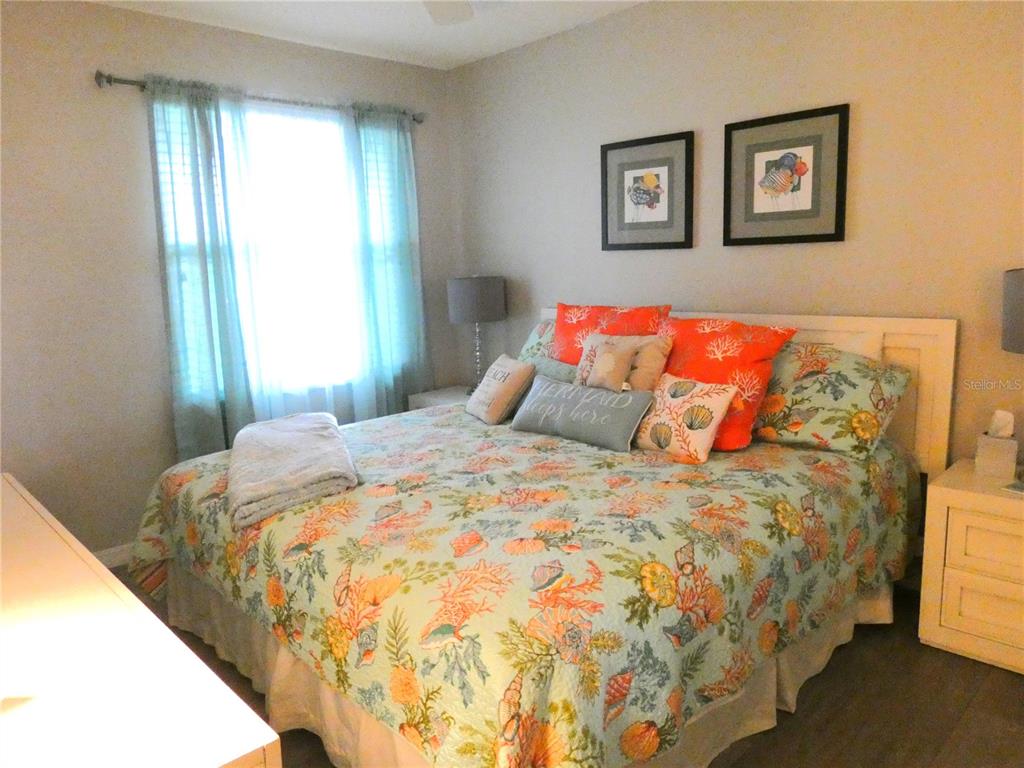 9320 Clubside Circle, Unit 2208 Sarasota, FL 34238 - Photo 19 of 41 a bed sitting in a bedroom next to a window