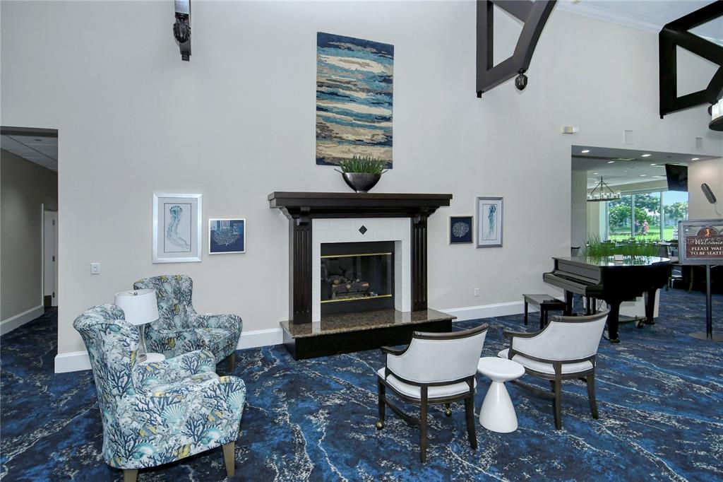 9320 Clubside Circle, Unit 2208 Sarasota, FL 34238 - Photo 29 of 41 a living room with furniture a window and a fireplace