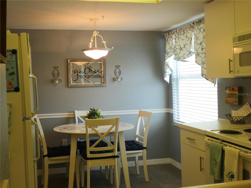 9320 Clubside Circle, Unit 2208 Sarasota, FL 34238 - Photo 3 of 41 a view of a dining room with furniture and window