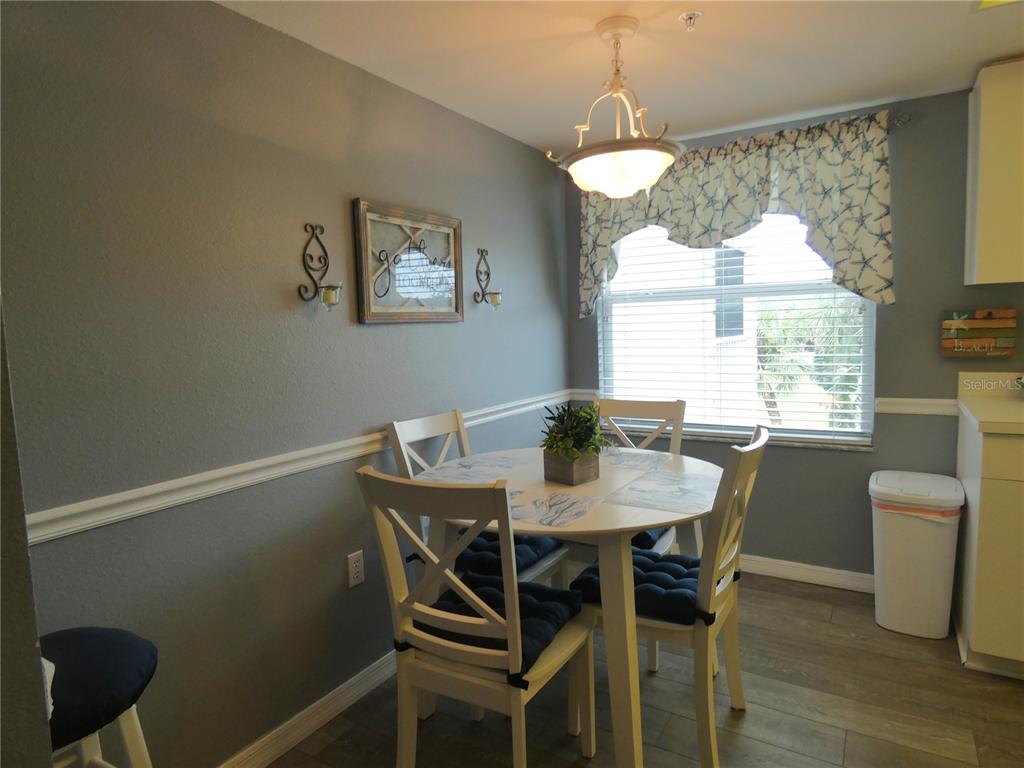 9320 Clubside Circle, Unit 2208 Sarasota, FL 34238 - Photo 4 of 41 a view of a dining room with furniture window and wooden floor