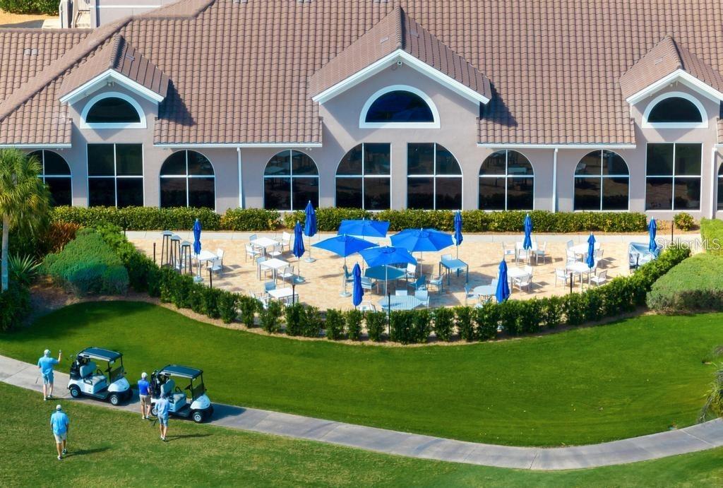 9320 Clubside Circle, Unit 2208 Sarasota, FL 34238 - Photo 41 of 41 a view of a white house with a yard table and chairs