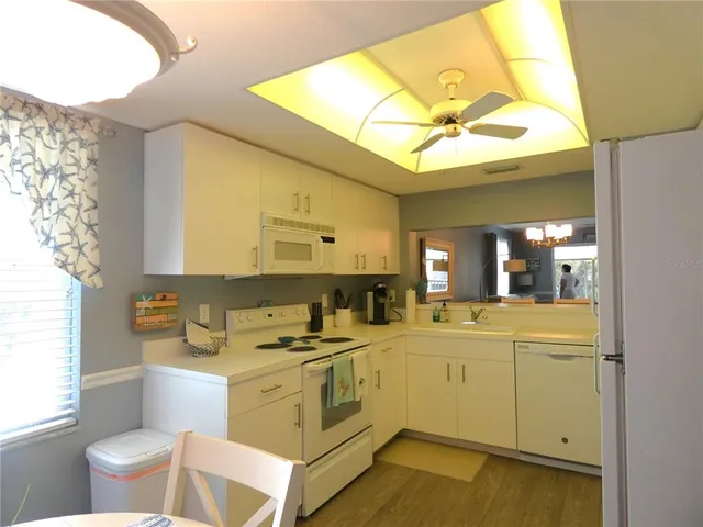 a kitchen with a sink cabinets and wooden floor