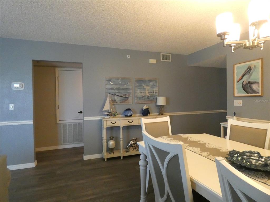 9320 Clubside Circle, Unit 2208 Sarasota, FL 34238 - Photo 9 of 41 a room with a wooden floor and a stove