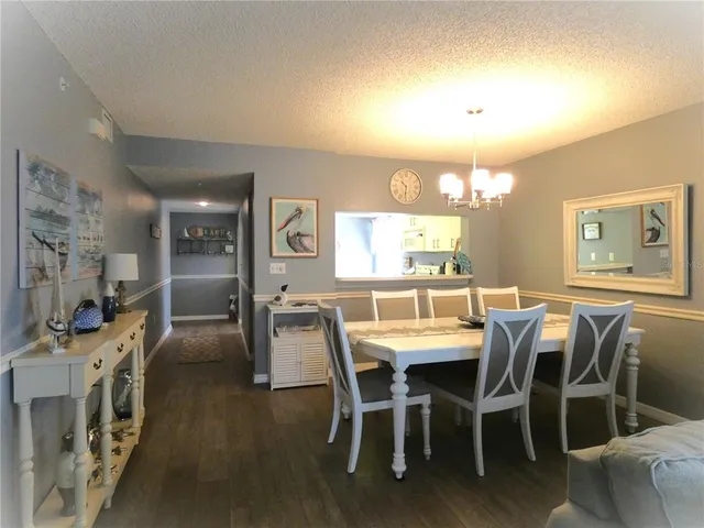 a dining room with furniture and chandelier