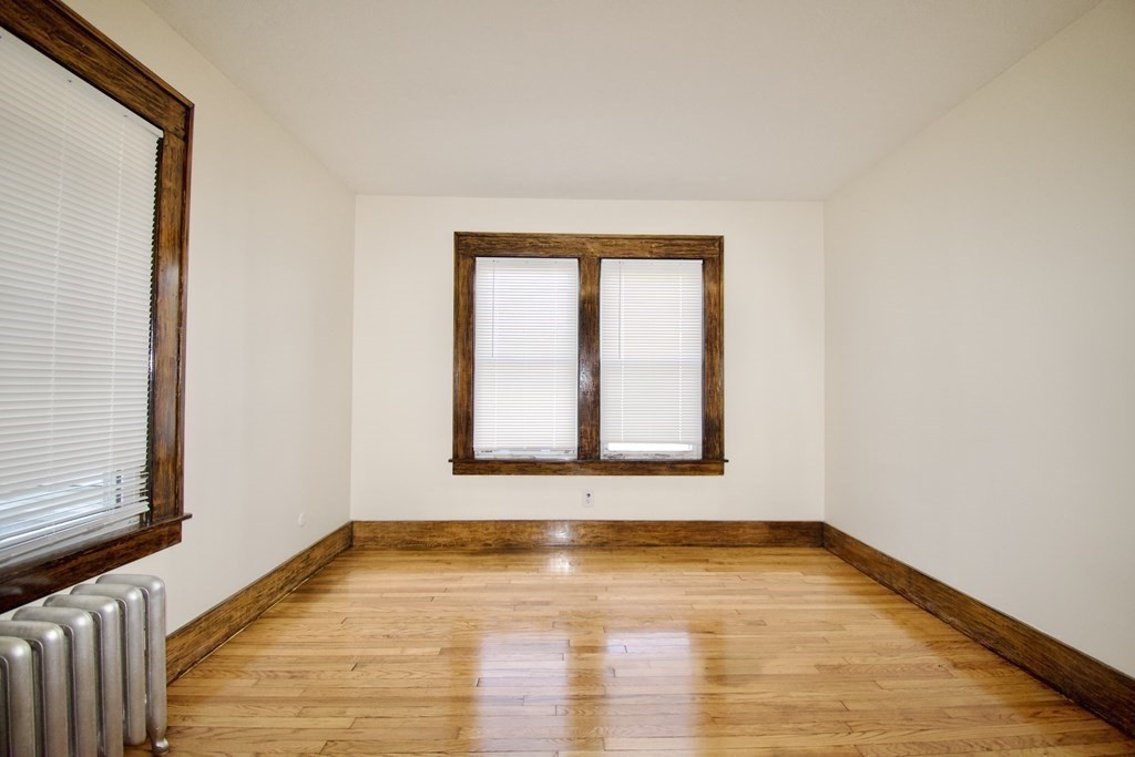 19 Ambrose Street Springfield, MA 01109 - Photo 14 of 32 a view of an empty room with wooden floor and a window
