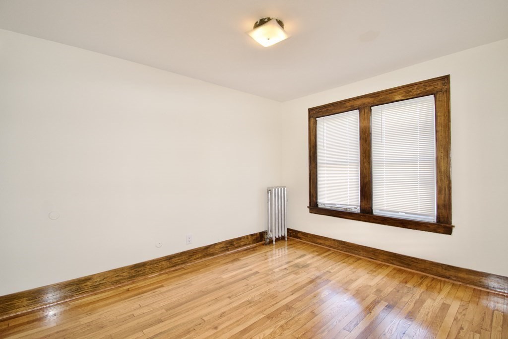 19 Ambrose Street Springfield, MA 01109 - Photo 15 of 32 an empty room with wooden floor and windows