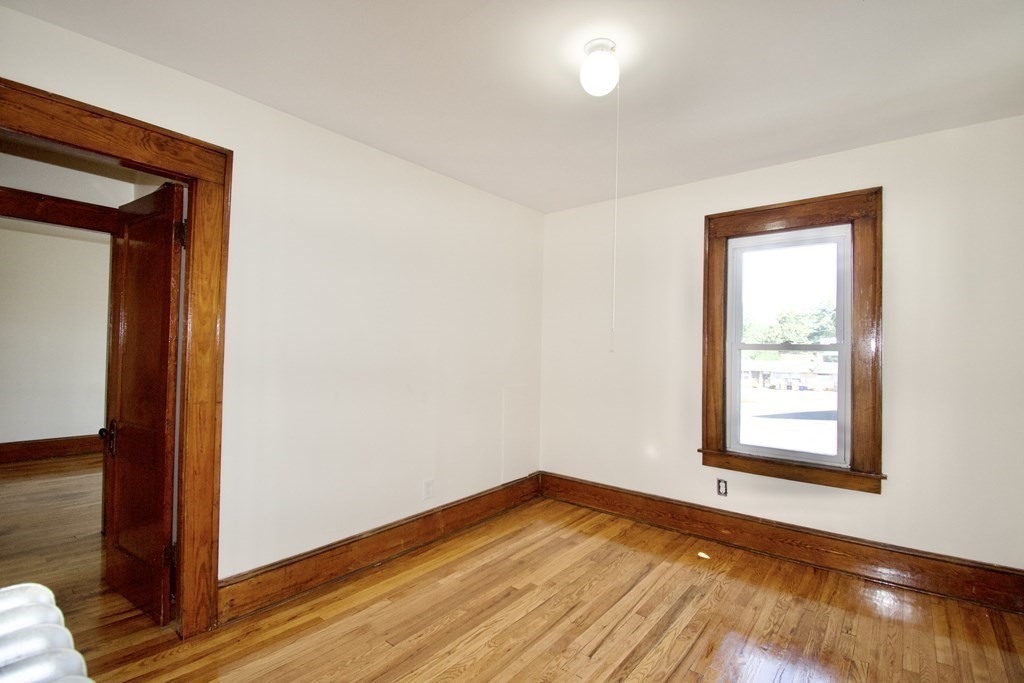 19 Ambrose Street Springfield, MA 01109 - Photo 16 of 32 a view of empty room with wooden floor and fan