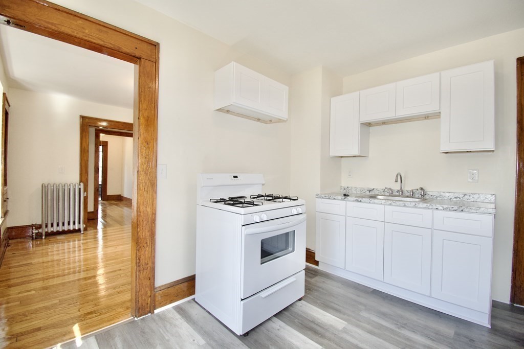 19 Ambrose Street Springfield, MA 01109 - Photo 18 of 32 a kitchen with a sink cabinets and wooden floor