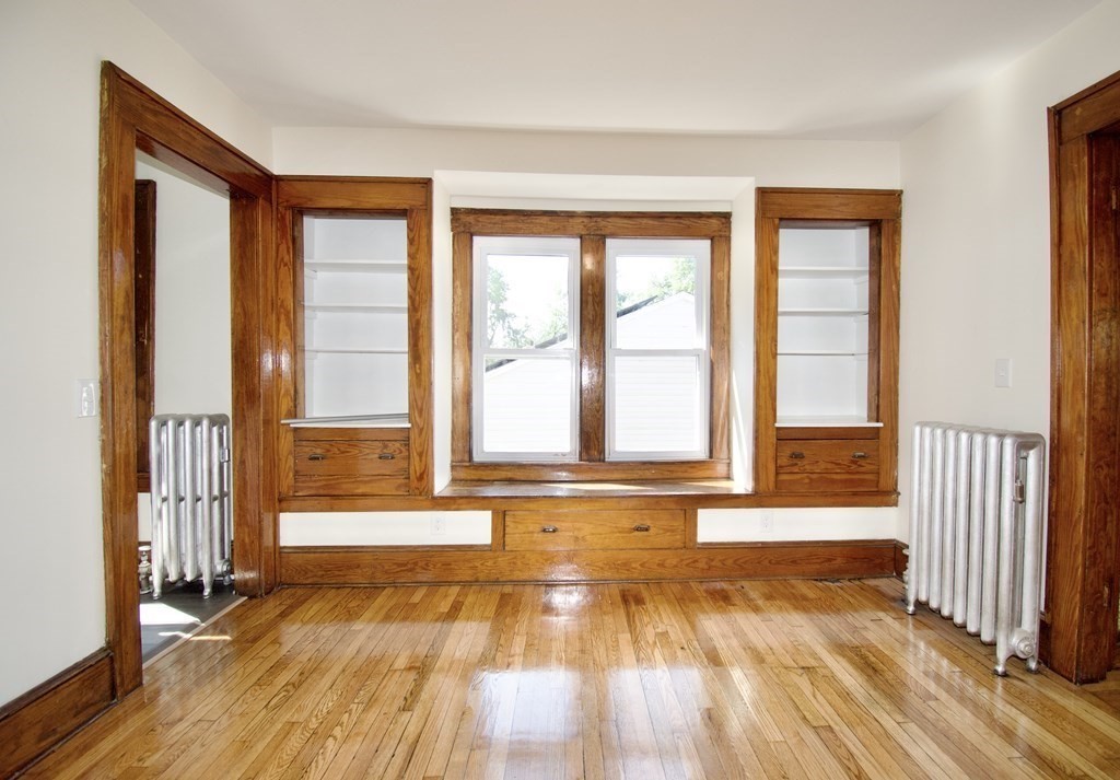19 Ambrose Street Springfield, MA 01109 - Photo 21 of 32 a view of an empty room with wooden floor and a window