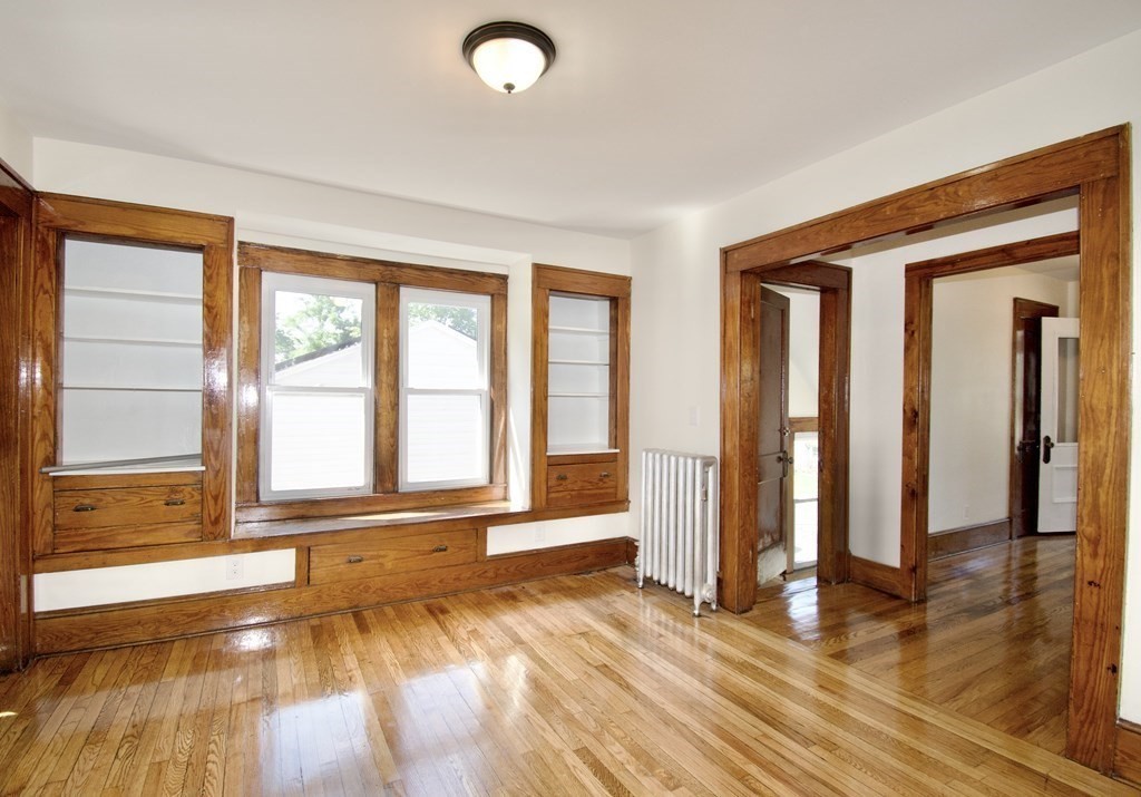 19 Ambrose Street Springfield, MA 01109 - Photo 22 of 32 a view of an empty room with wooden floor and a window
