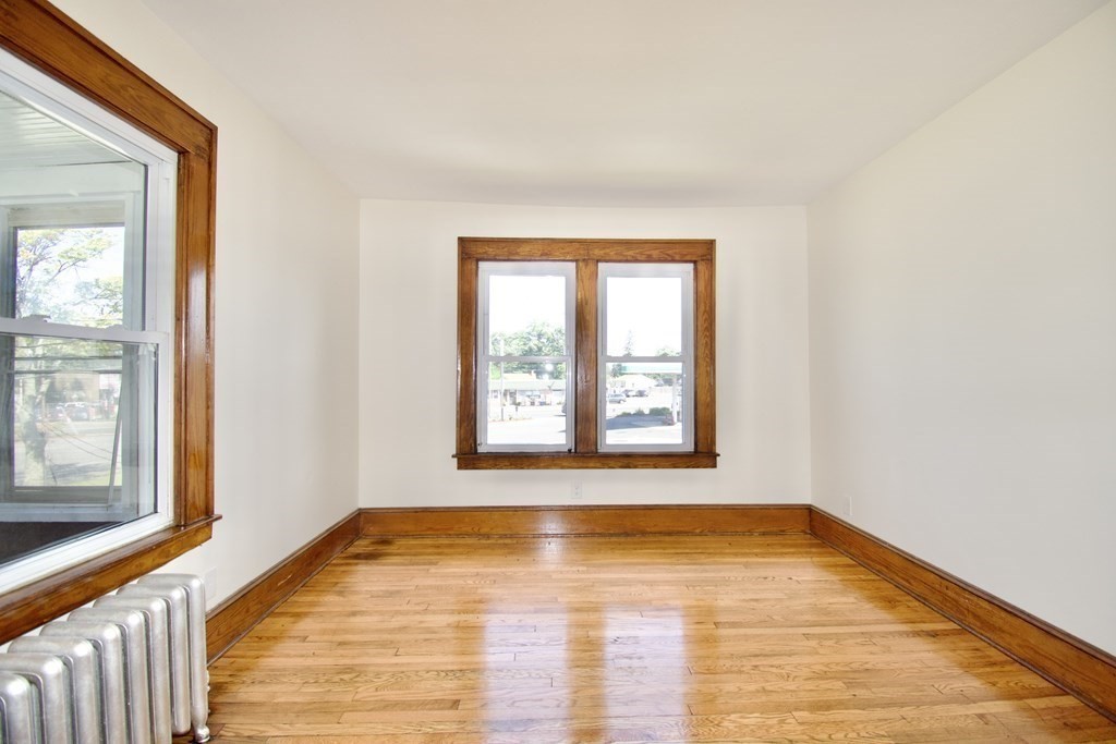 19 Ambrose Street Springfield, MA 01109 - Photo 23 of 32 a view of an empty room with wooden floor and a window