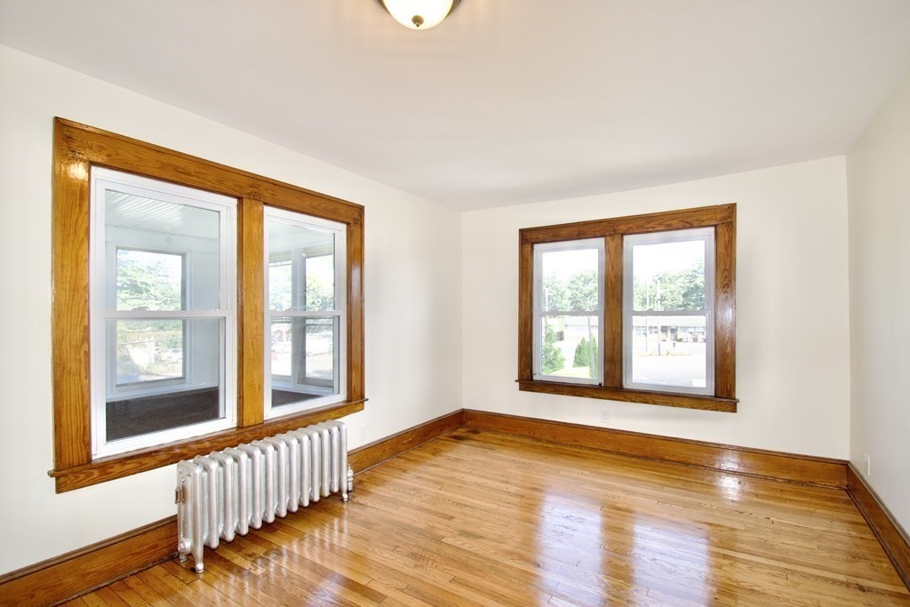 19 Ambrose Street Springfield, MA 01109 - Photo 24 of 32 a view of an empty room with wooden floor and a window