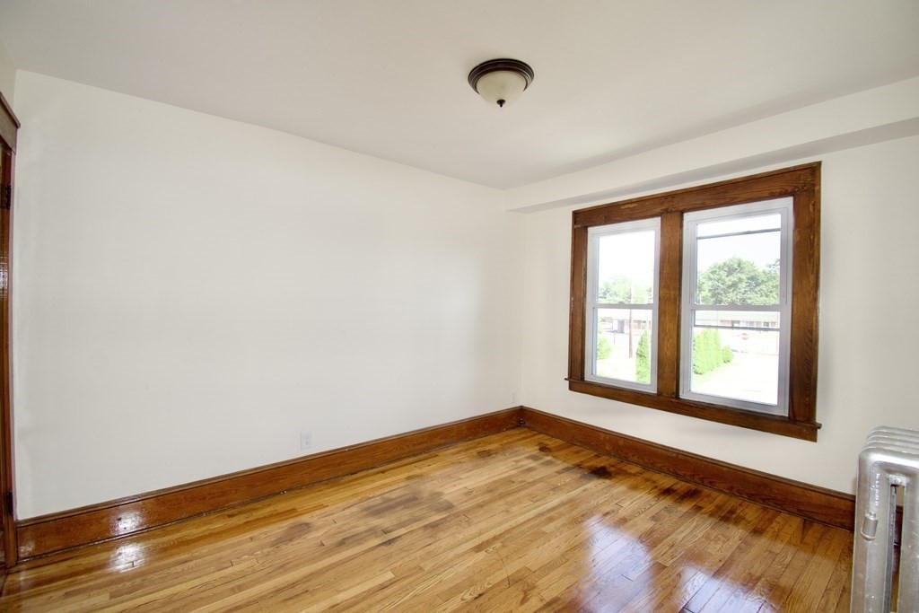 19 Ambrose Street Springfield, MA 01109 - Photo 25 of 32 a view of empty room with wooden floor and fan