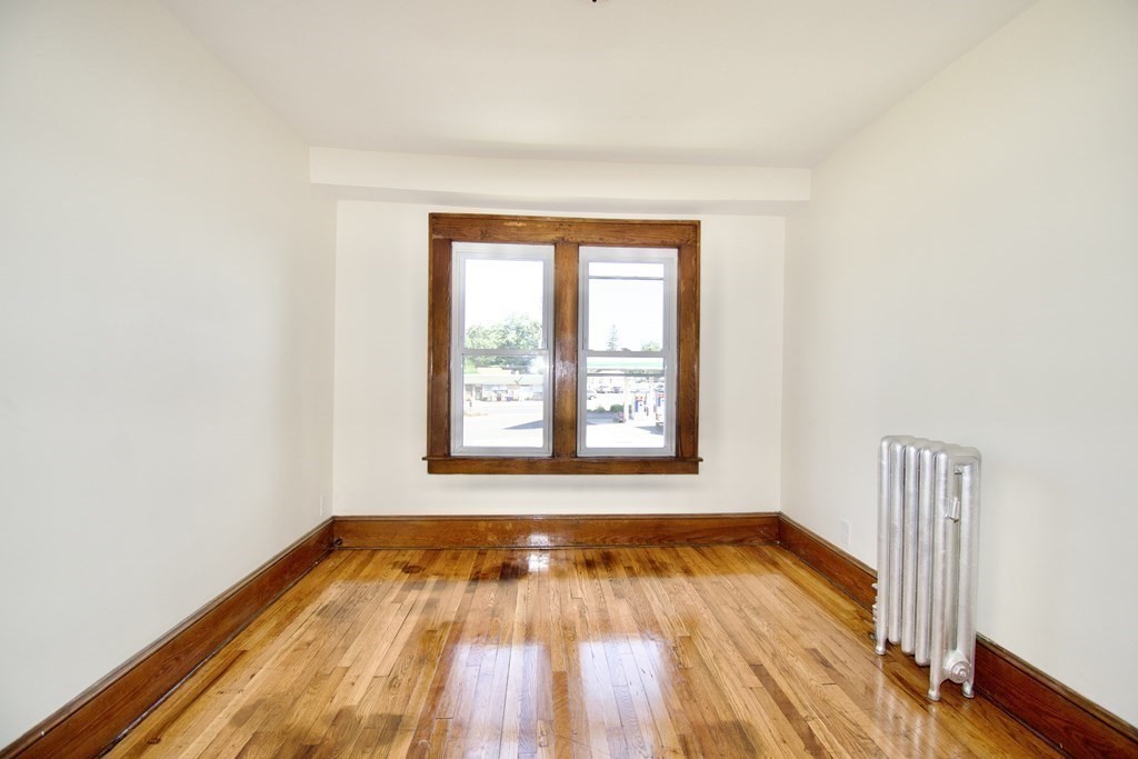 19 Ambrose Street Springfield, MA 01109 - Photo 26 of 32 an empty room with wooden floor and windows
