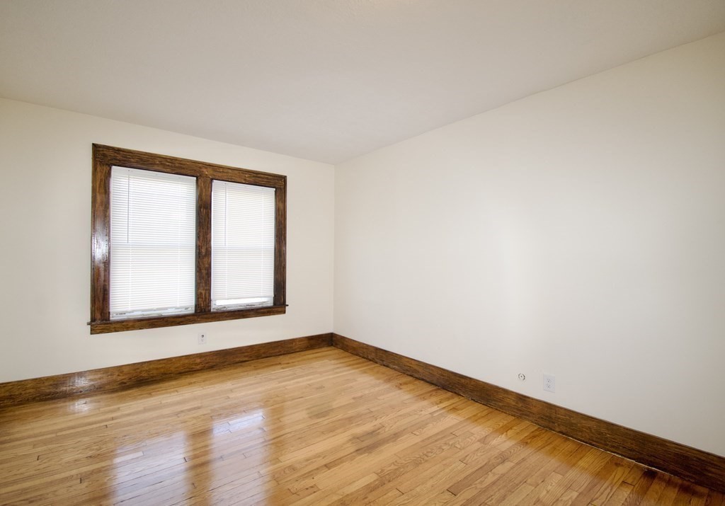 19 Ambrose Street Springfield, MA 01109 - Photo 27 of 32 a view of an empty room with wooden floor and a window