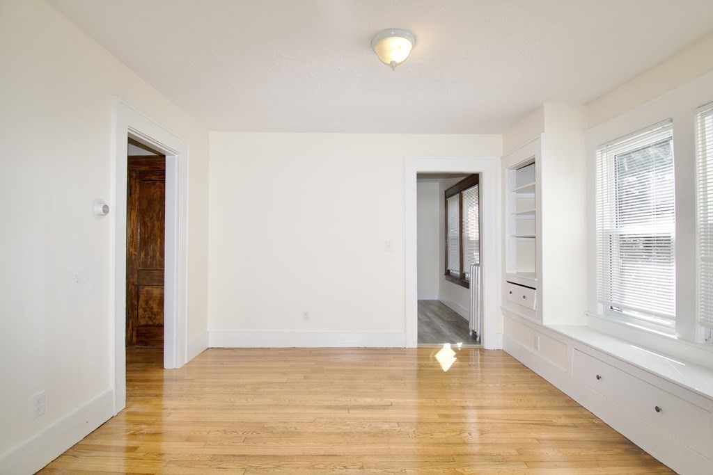 19 Ambrose Street Springfield, MA 01109 - Photo 4 of 32 a view of an empty room with window and wooden floor