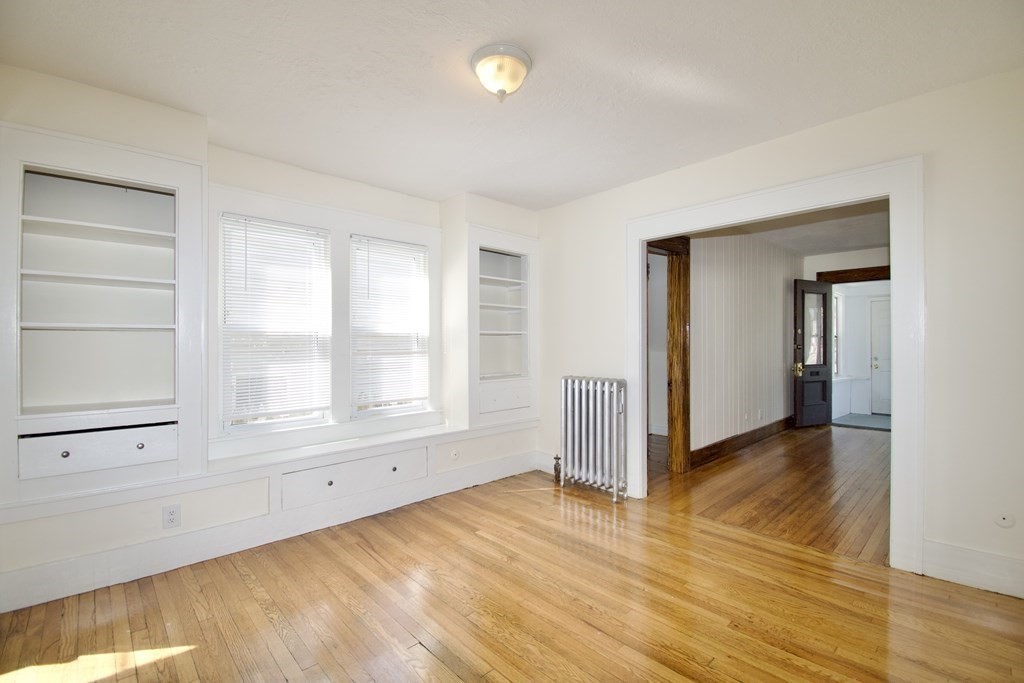 19 Ambrose Street Springfield, MA 01109 - Photo 6 of 32 a view of an empty room with wooden floor and a window