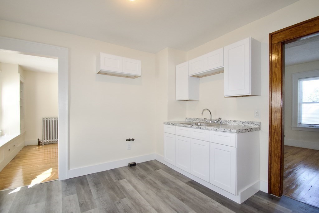 19 Ambrose Street Springfield, MA 01109 - Photo 7 of 32 a view of a kitchen with sink and dishwasher with wooden floor