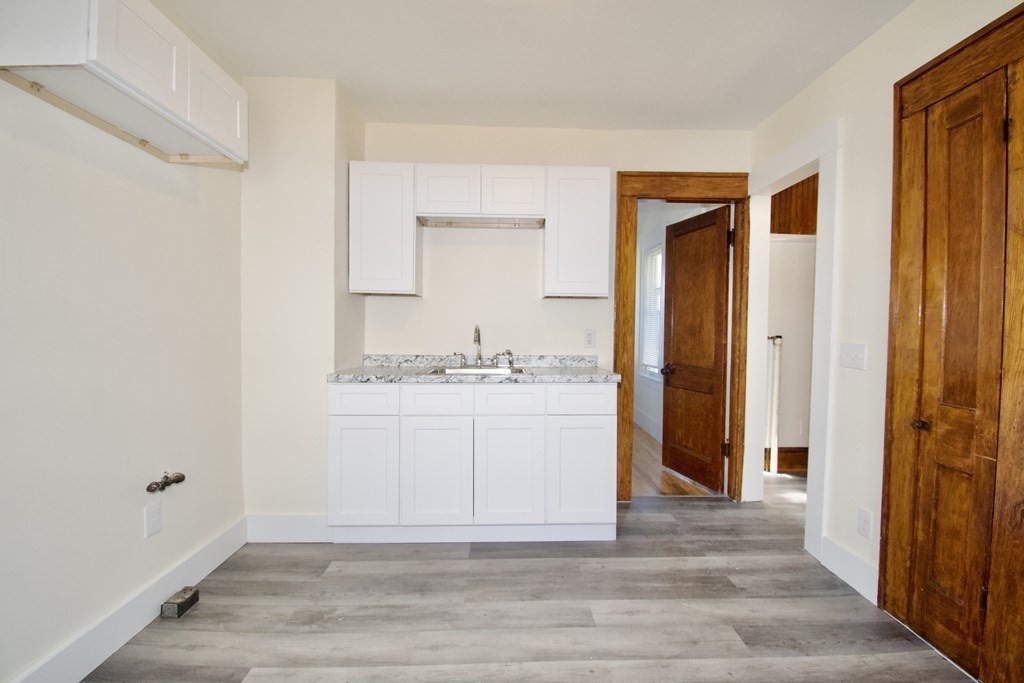 19 Ambrose Street Springfield, MA 01109 - Photo 8 of 32 a bathroom with a granite countertop sink and a mirror