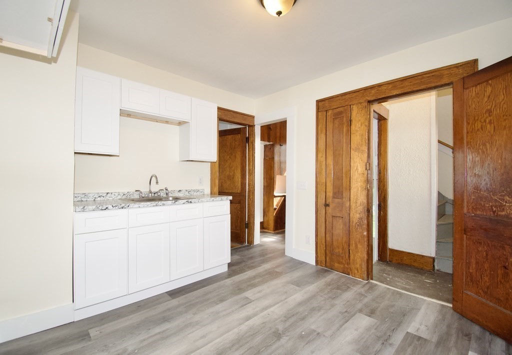 19 Ambrose Street Springfield, MA 01109 - Photo 9 of 32 a bathroom with a granite countertop sink and a mirror