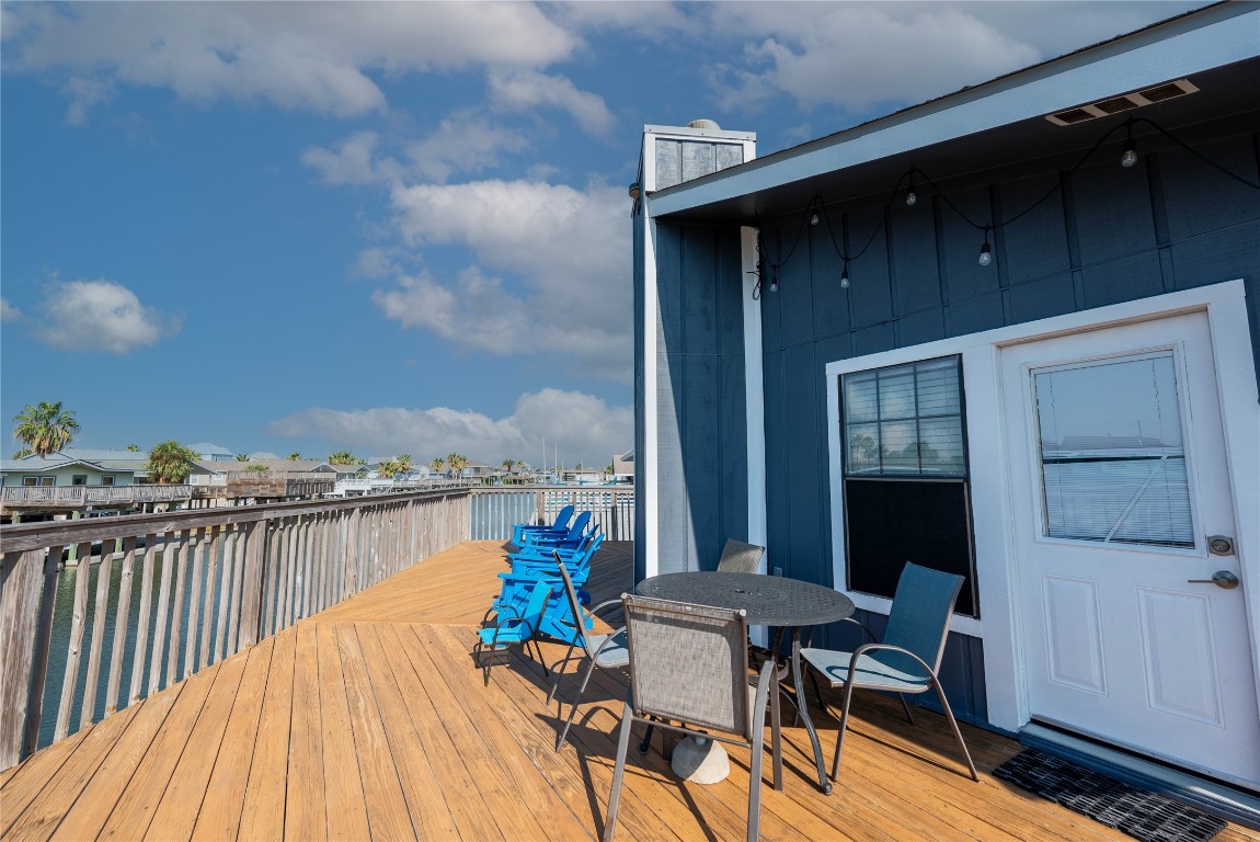 4729 Jolly Roger Road Jamaica Beach, TX 77554 - Photo 11 of 45 a view of a balcony with two chairs and a table