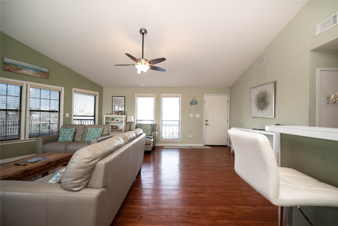 4729 Jolly Roger Road Jamaica Beach, TX 77554 - Photo 16 of 45 a living room with furniture and a chandelier