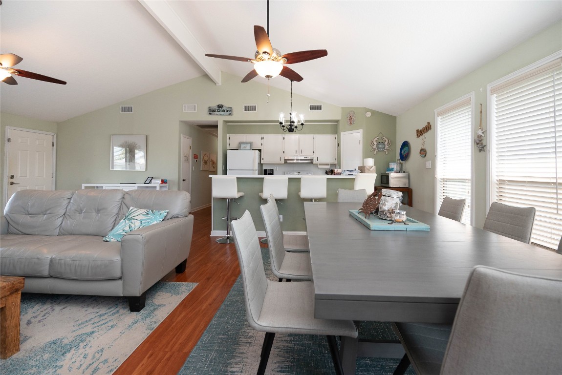 4729 Jolly Roger Road Jamaica Beach, TX 77554 - Photo 18 of 45 a living room with kitchen island furniture and a chandelier