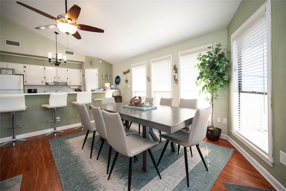 4729 Jolly Roger Road Jamaica Beach, TX 77554 - Photo 19 of 45 a view of a dining room with furniture window and wooden floor