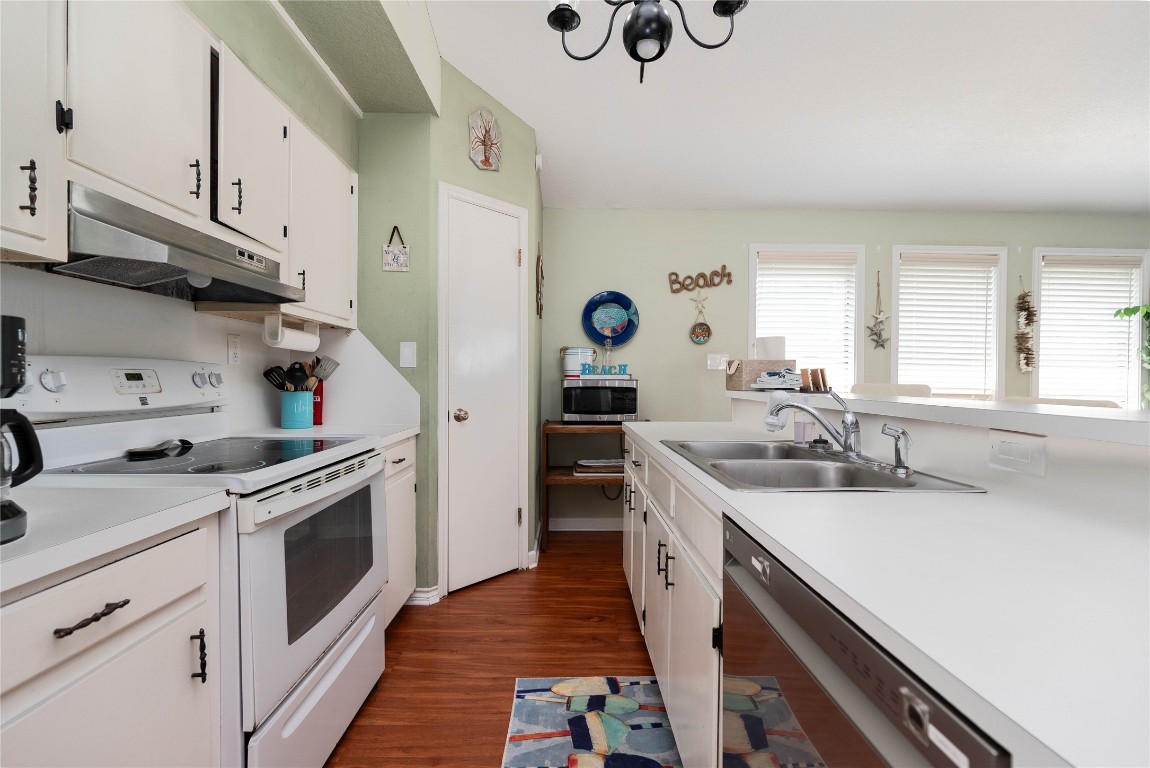4729 Jolly Roger Road Jamaica Beach, TX 77554 - Photo 22 of 45 a kitchen with a sink stove and cabinets