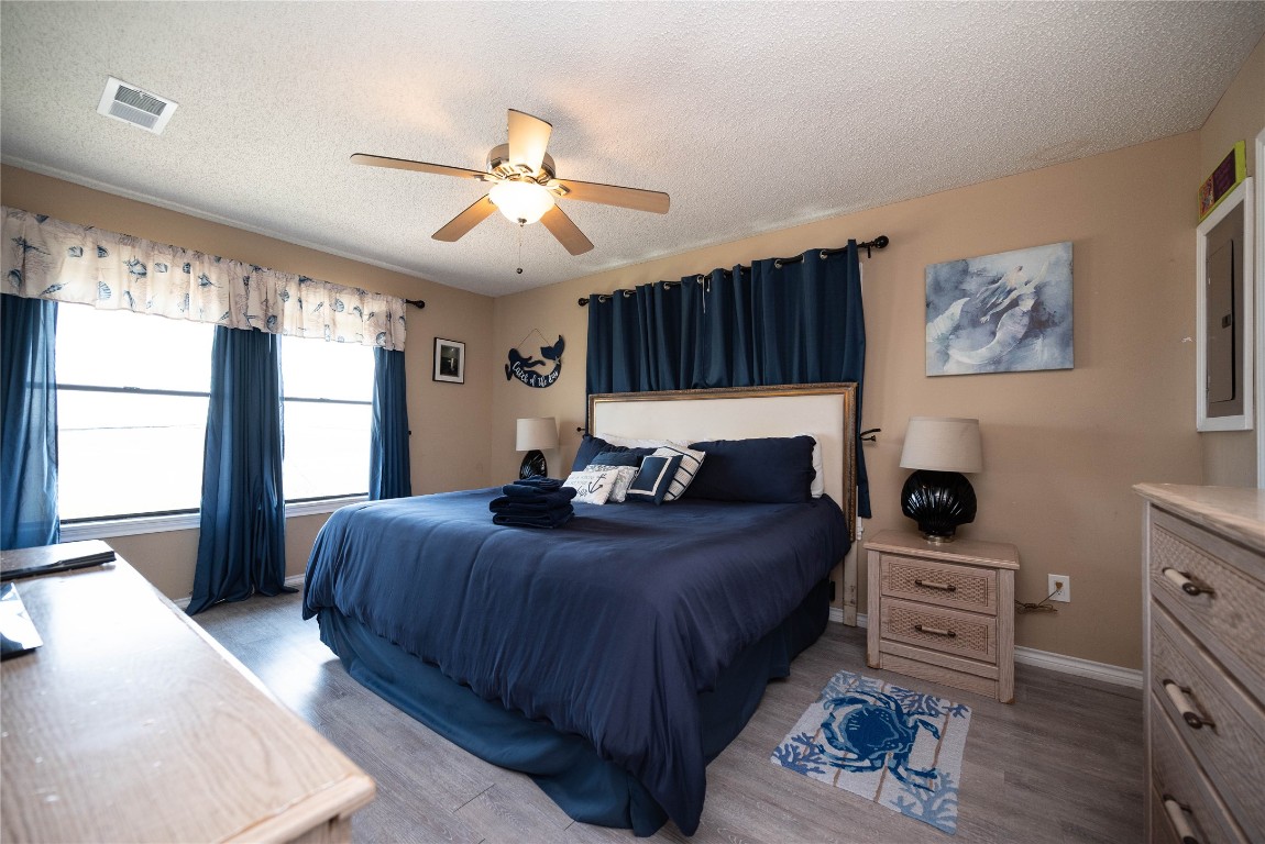 4729 Jolly Roger Road Jamaica Beach, TX 77554 - Photo 23 of 45 a bedroom with a bed a couch and a window