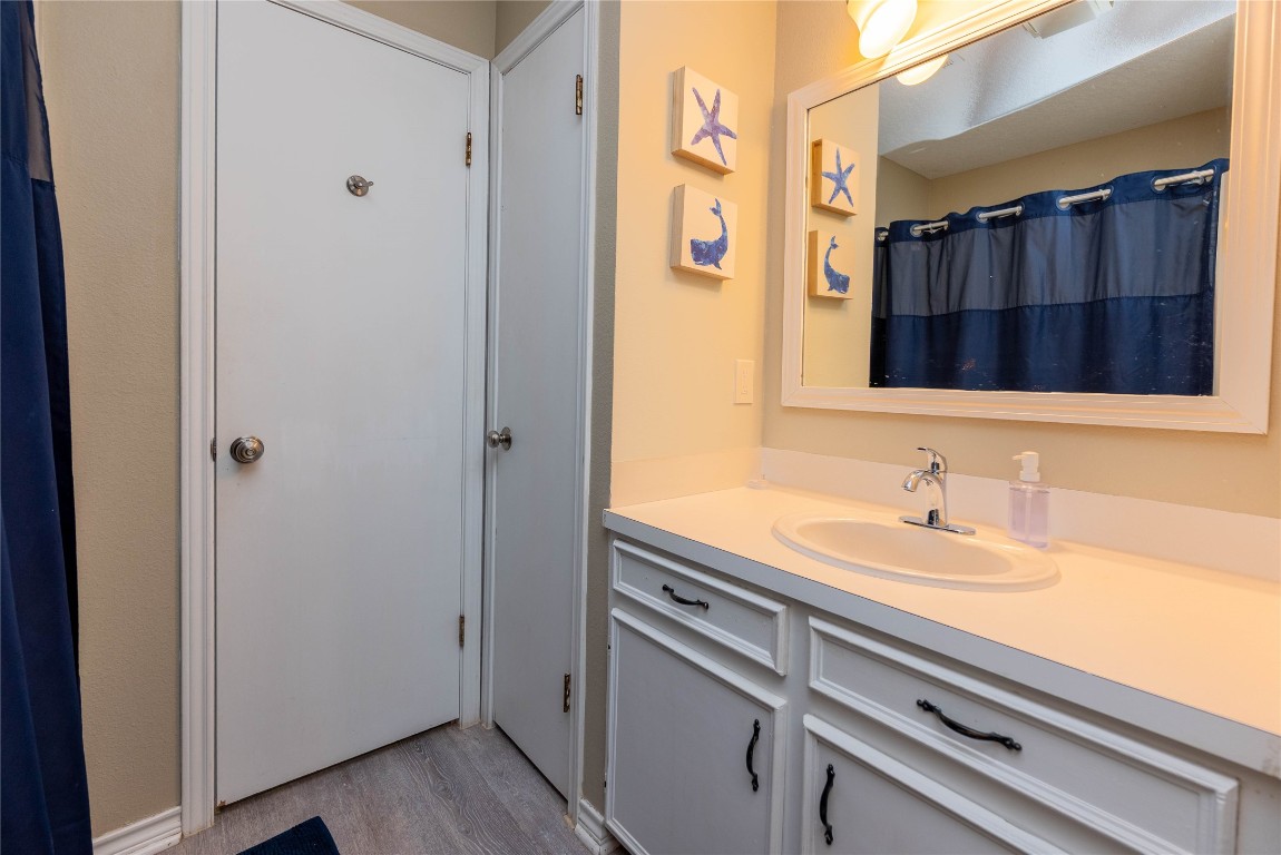 4729 Jolly Roger Road Jamaica Beach, TX 77554 - Photo 26 of 45 a bathroom with a sink and a mirror